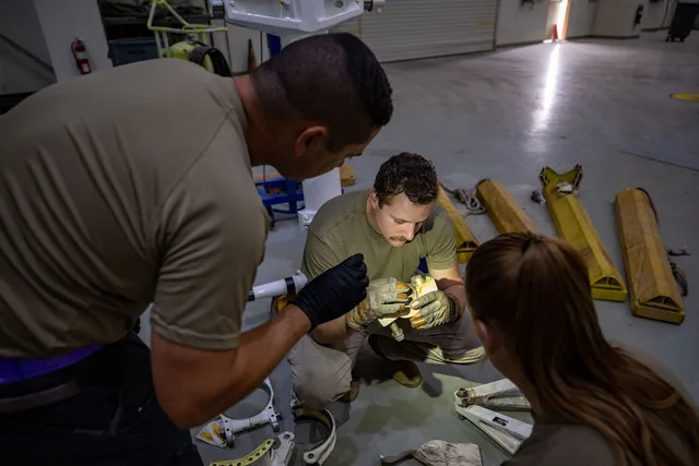 From the left, Master Sgt. Maxwell Spates, Staff Sgt. Zachary Hoaglin and Tech. Sgt. Katherine O’Hara, 379th Expeditionary Maintenance Squadron repair and reclamation technicians, inspect parts within the U.S. Central Command area of responsibility, Sept. 4, 2025. The 379th EMXS performs maintenance. Replacement part and tool checklist for matching, shipping, and storage